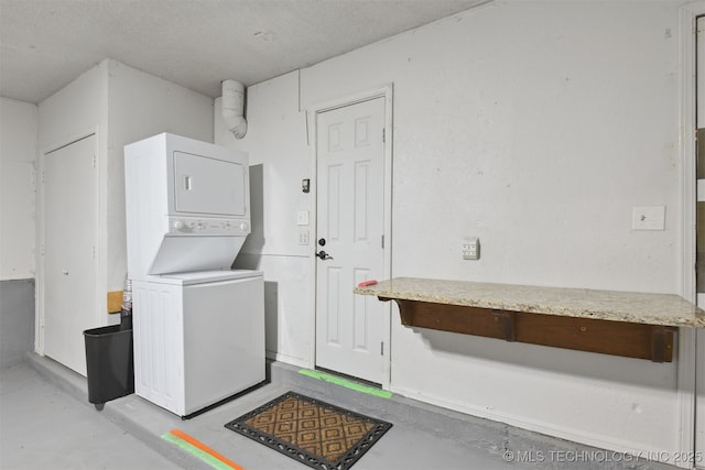 washroom featuring stacked washer / dryer