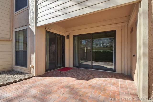 property entrance featuring a patio area