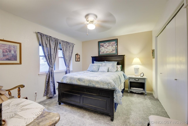 bedroom featuring ceiling fan, baseboards, a closet, and light colored carpet