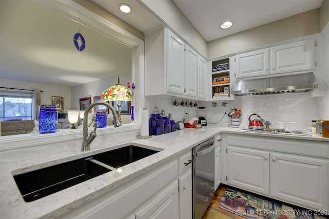 kitchen with under cabinet range hood, stainless steel appliances, a sink, white cabinetry, and backsplash