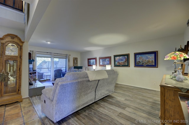 living room with baseboards and wood finished floors