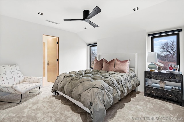 carpeted bedroom with ceiling fan and lofted ceiling