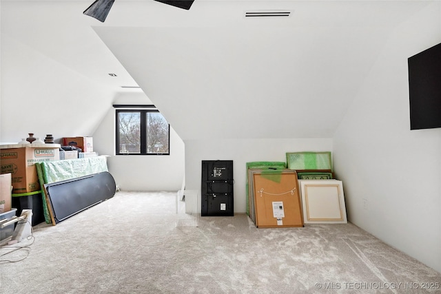 additional living space featuring vaulted ceiling, light carpet, and ceiling fan