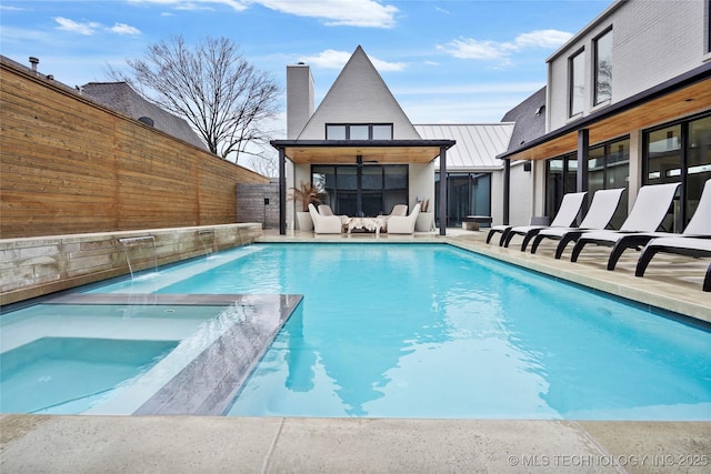 view of swimming pool featuring pool water feature and a patio area