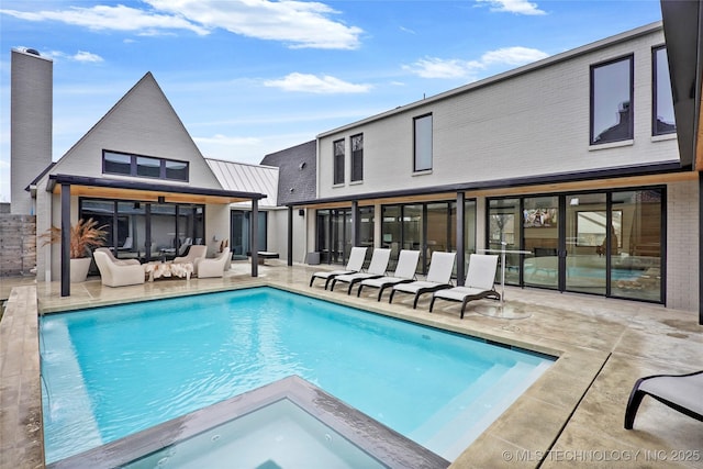 view of swimming pool with an outdoor living space and a patio
