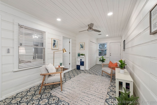 interior space with ceiling fan and wooden ceiling