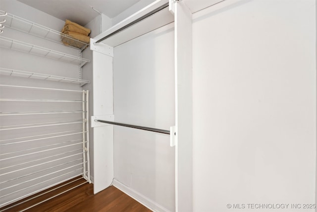 walk in closet featuring dark wood-type flooring