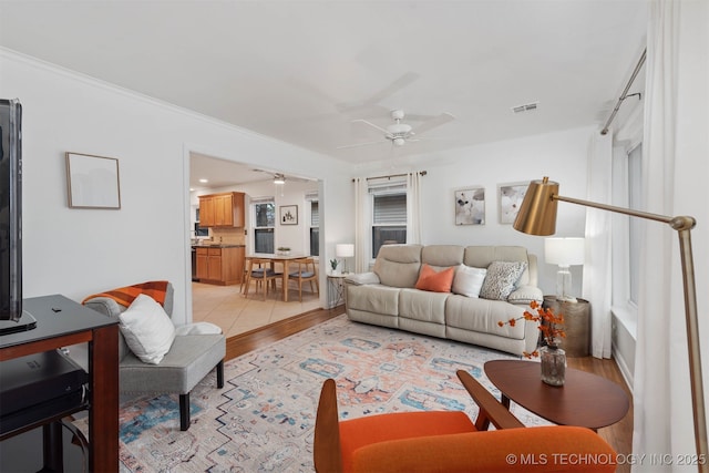 living room featuring ceiling fan and light wood-type flooring