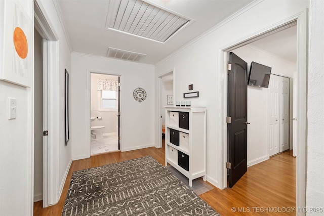 hall featuring crown molding and hardwood / wood-style flooring