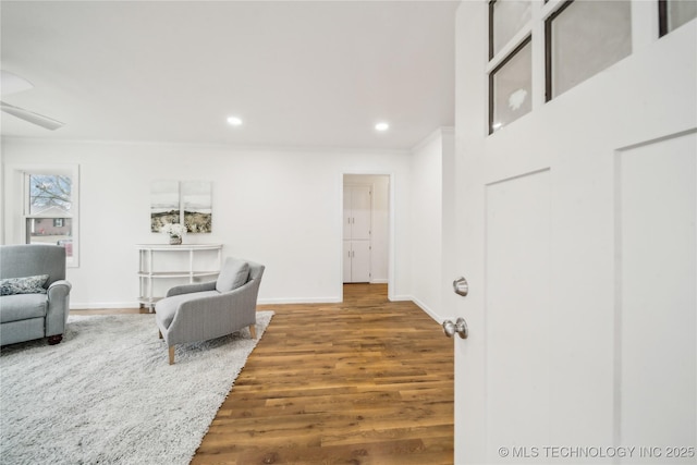 interior space featuring wood-type flooring and ornamental molding