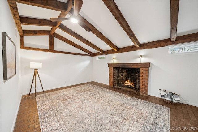 unfurnished living room featuring a healthy amount of sunlight, a brick fireplace, and vaulted ceiling with beams