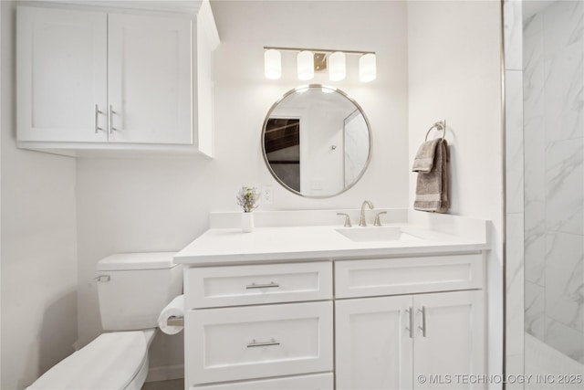 bathroom with vanity, walk in shower, and toilet