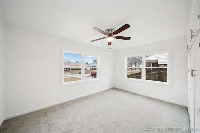 empty room featuring light carpet and ceiling fan