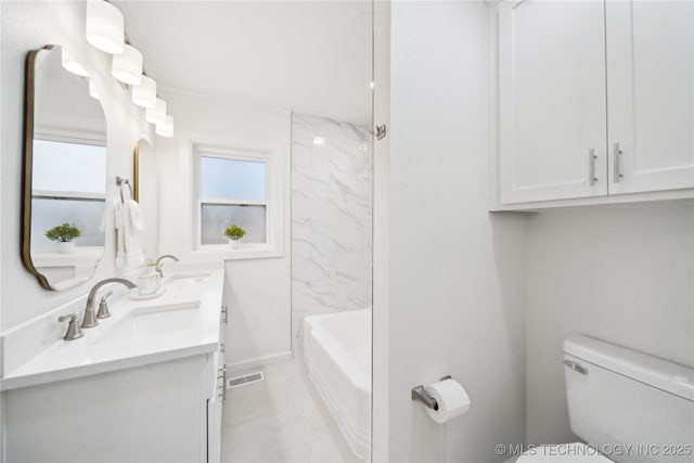 full bathroom with vanity, toilet, and tiled shower / bath combo