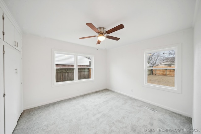 unfurnished bedroom with ceiling fan and light carpet