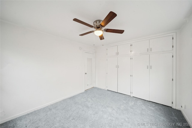 unfurnished bedroom with light colored carpet, a closet, and ceiling fan