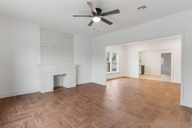 unfurnished living room featuring parquet floors, ornamental molding, and a stone fireplace