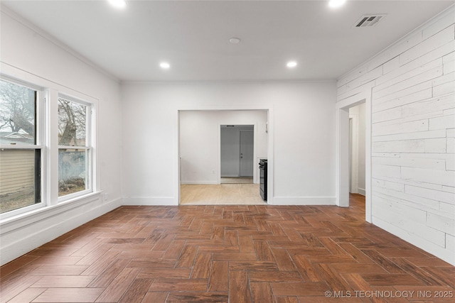 unfurnished room featuring dark parquet flooring and ornamental molding