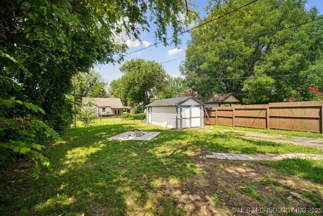 view of yard with an outdoor fire pit and a shed