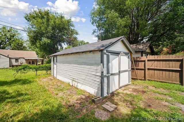 view of outbuilding featuring a lawn