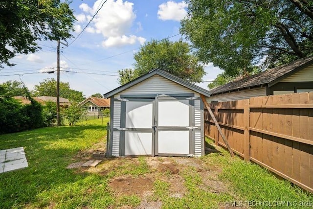 view of outdoor structure featuring a lawn