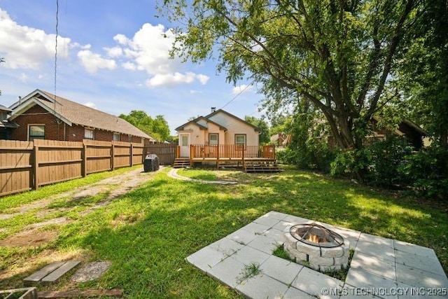 view of yard with a wooden deck, a patio, and an outdoor fire pit