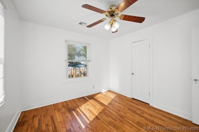 unfurnished bedroom with hardwood / wood-style floors, ceiling fan, and a closet