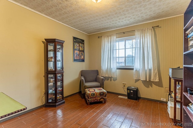 unfurnished room with ornamental molding, hardwood / wood-style floors, and a textured ceiling