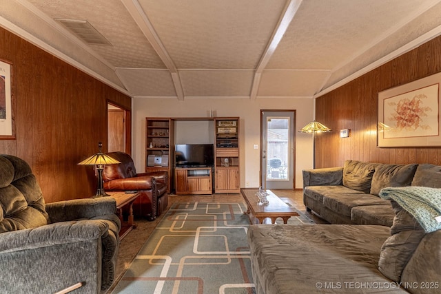 living room featuring wooden walls and vaulted ceiling