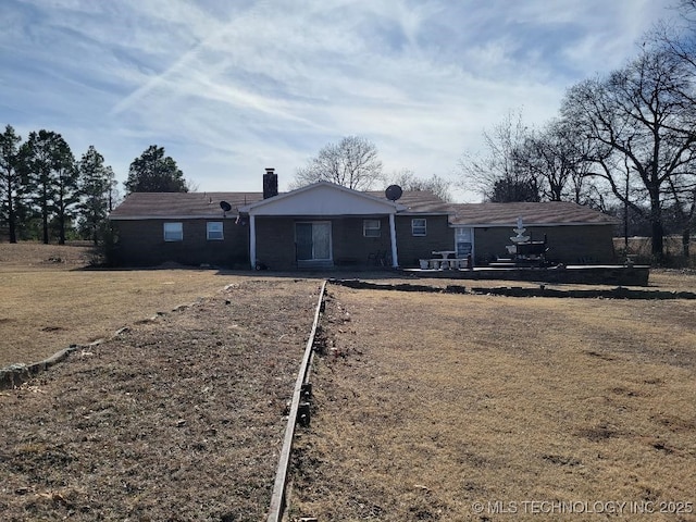 back of house with a lawn