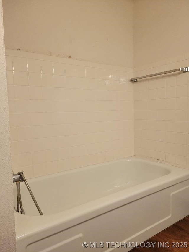 bathroom featuring a bath and wood-type flooring