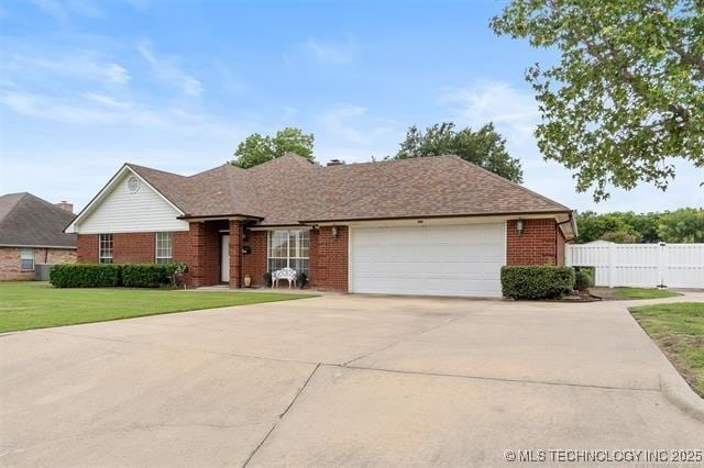 ranch-style house featuring a garage and a front yard