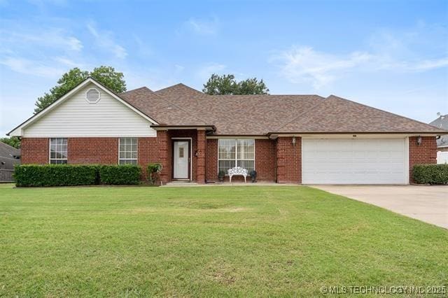 ranch-style house featuring a garage and a front lawn