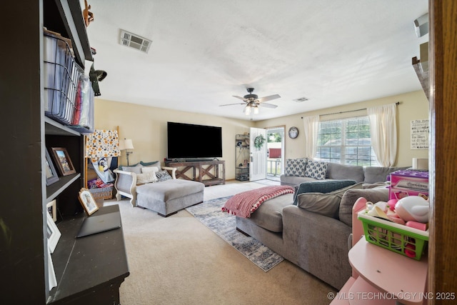 living room featuring carpet flooring and ceiling fan