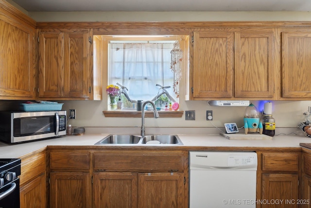 kitchen with white dishwasher, sink, and black range with gas stovetop