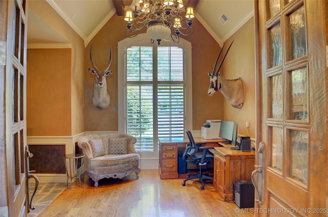 office with light hardwood / wood-style flooring, vaulted ceiling, ornamental molding, and a healthy amount of sunlight