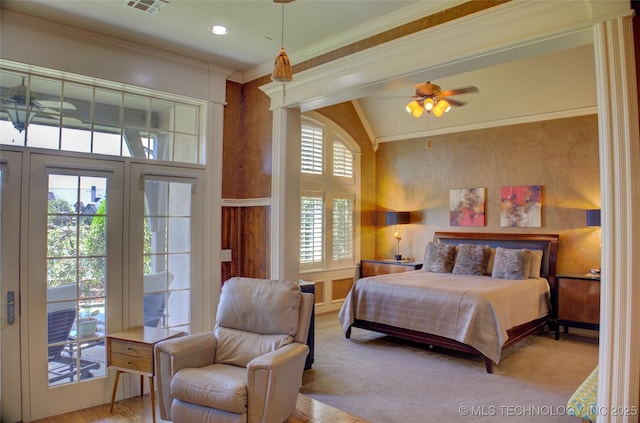 bedroom with crown molding, light colored carpet, vaulted ceiling, and access to outside