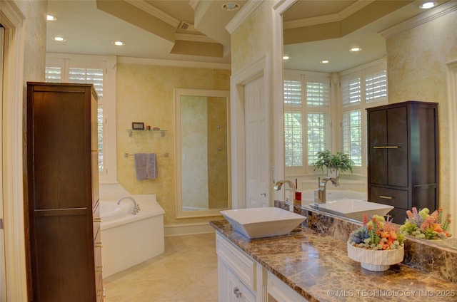 bathroom featuring crown molding, tile patterned floors, vanity, and a bathtub