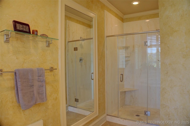 bathroom featuring a shower with shower door and ornamental molding