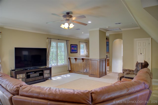 carpeted living room featuring ornamental molding and ceiling fan