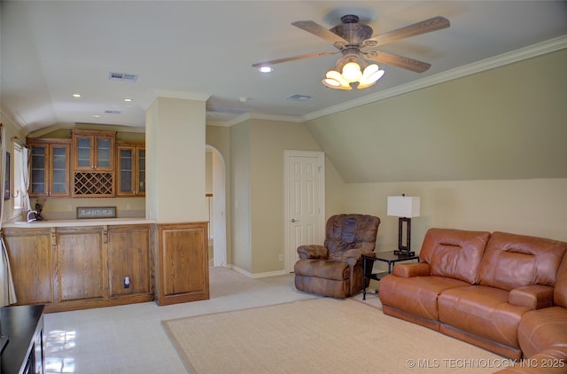 living room featuring ornamental molding, lofted ceiling, light colored carpet, and ceiling fan