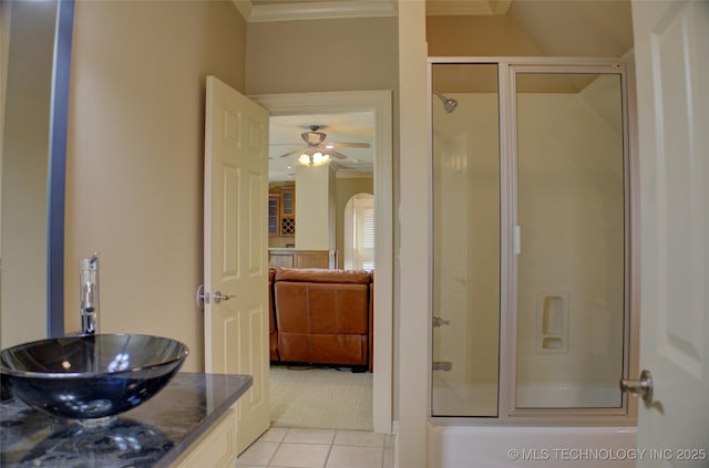 bathroom with combined bath / shower with glass door, sink, tile patterned flooring, ornamental molding, and ceiling fan