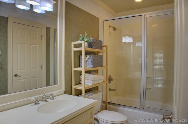 full bathroom featuring vanity, ornamental molding, toilet, and combined bath / shower with glass door