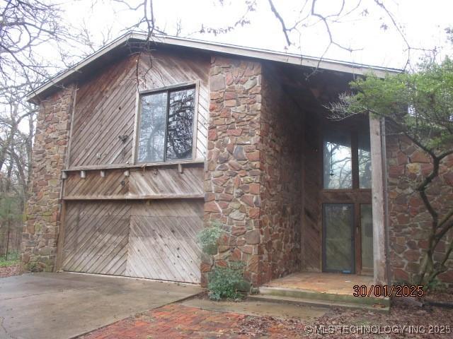 exterior space with stone siding