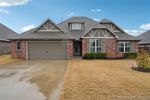 view of front of property with a garage and a front lawn