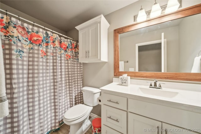 bathroom featuring vanity and toilet