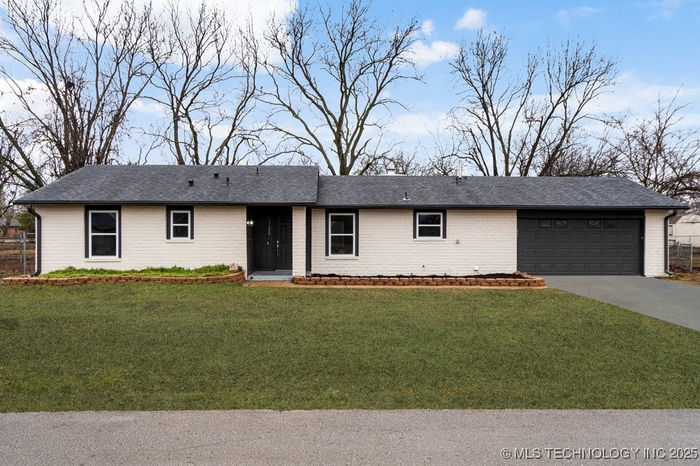 single story home with a garage and a front yard