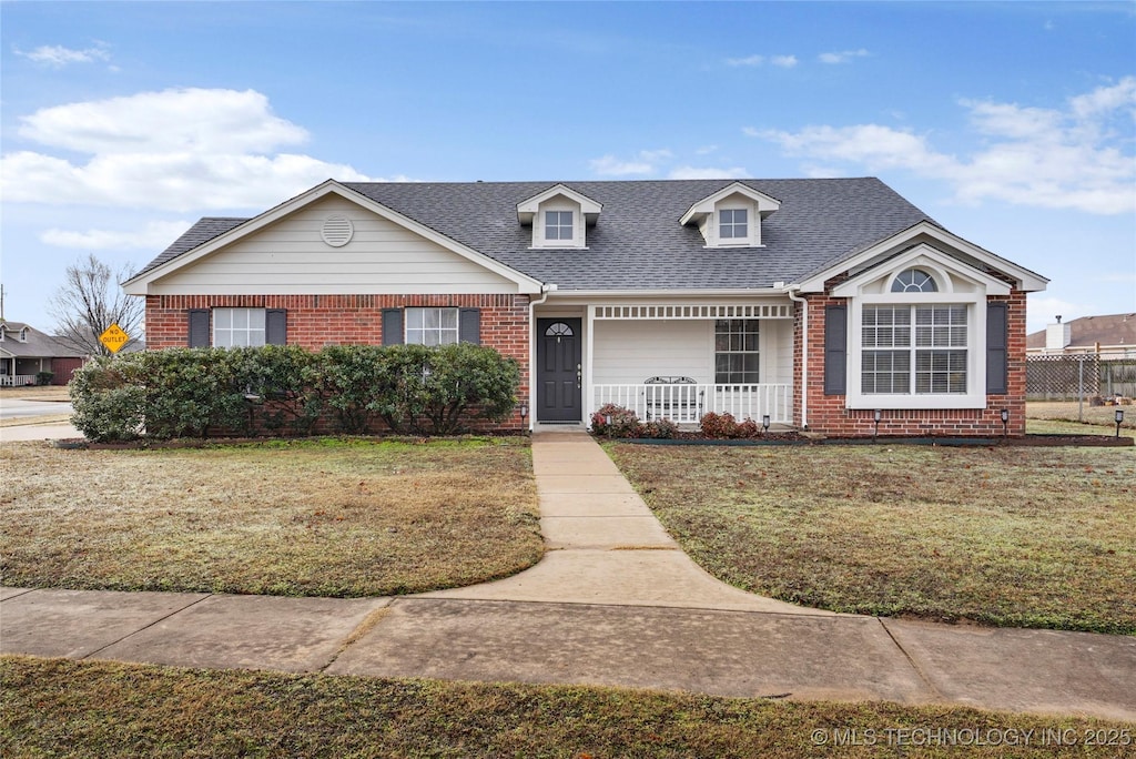 view of front of home with a front yard and covered porch