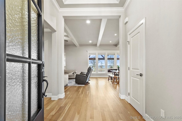 hallway featuring beamed ceiling, crown molding, and light hardwood / wood-style flooring