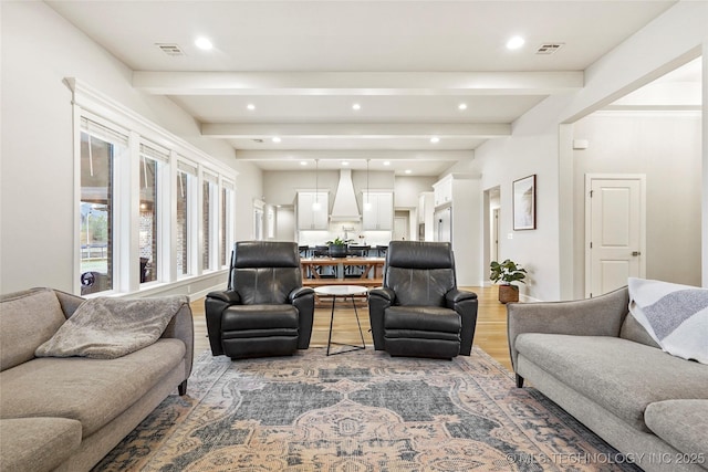 living room with hardwood / wood-style flooring and beamed ceiling